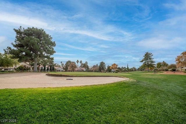 view of property's community with a lawn