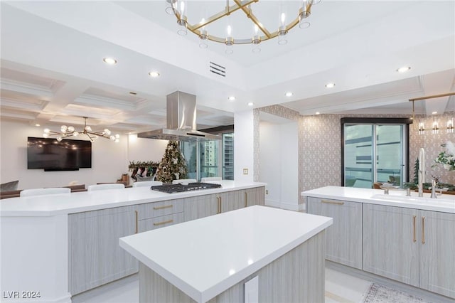 kitchen featuring island range hood, stainless steel gas stovetop, a large island, and sink