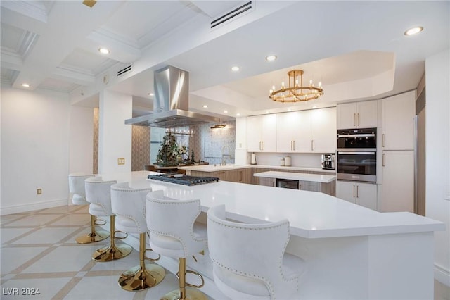 kitchen featuring ventilation hood, tasteful backsplash, white cabinetry, stainless steel appliances, and a chandelier