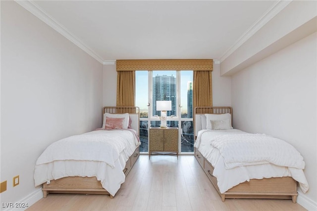 bedroom with ornamental molding and light hardwood / wood-style flooring