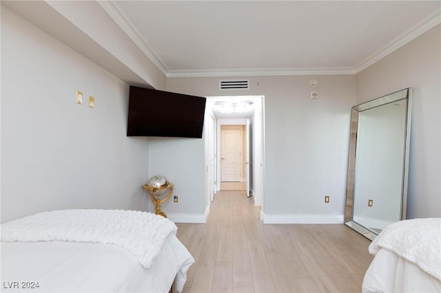 bedroom featuring light hardwood / wood-style flooring and ornamental molding