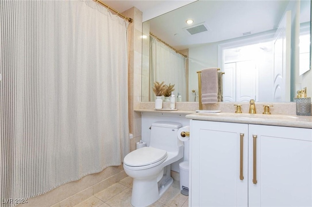 bathroom featuring tile patterned flooring, vanity, and toilet