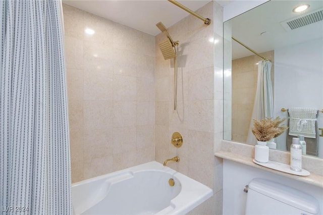 bathroom featuring toilet and shower / tub combo with curtain