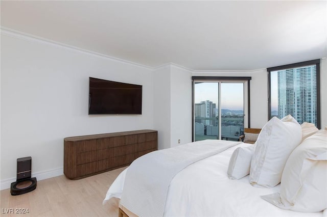 bedroom featuring ornamental molding, access to outside, and light hardwood / wood-style floors