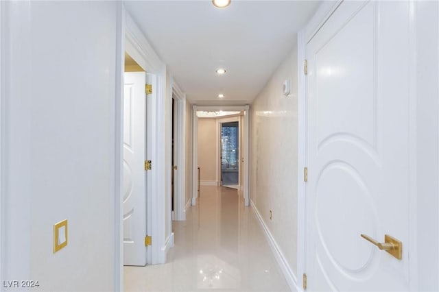 hall with light tile patterned floors