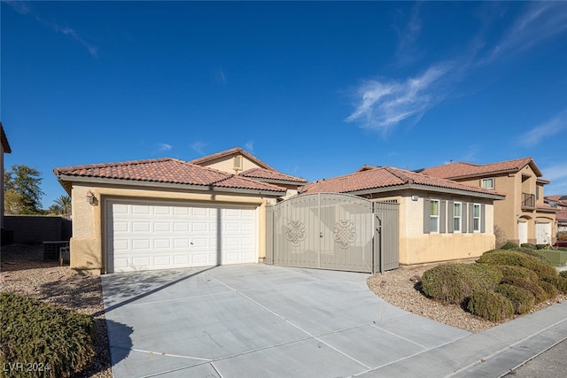 mediterranean / spanish-style home with a garage