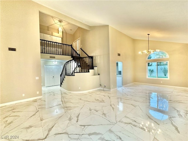 entrance foyer featuring beamed ceiling, a notable chandelier, and high vaulted ceiling