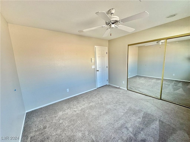 unfurnished bedroom featuring carpet flooring, ceiling fan, and a closet