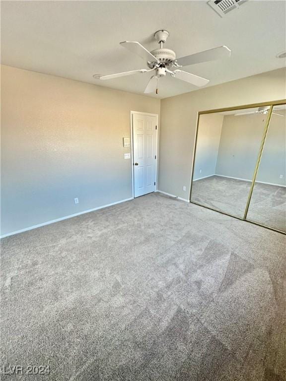 unfurnished bedroom with carpet flooring, a closet, and ceiling fan