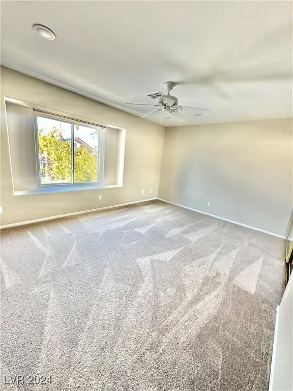 spare room with carpet floors and ceiling fan