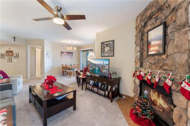 living room featuring ceiling fan with notable chandelier and light carpet