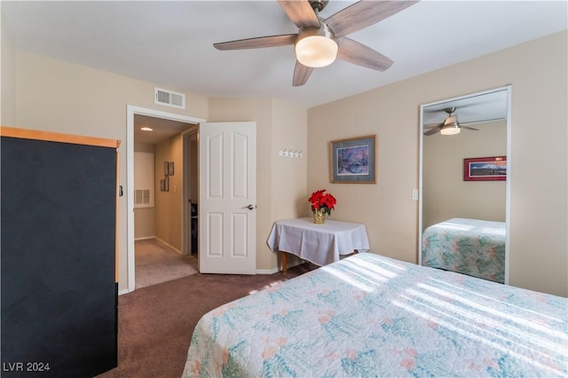 bedroom featuring dark colored carpet, a closet, and ceiling fan