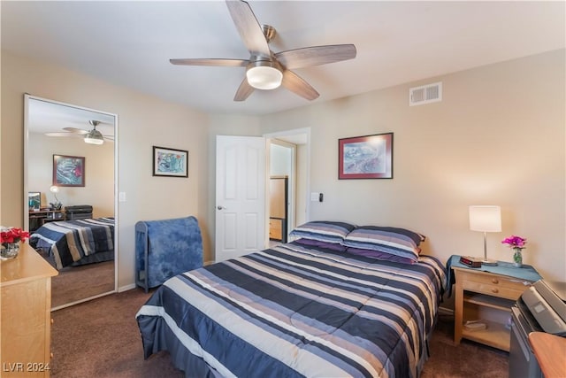 carpeted bedroom featuring ceiling fan and a closet