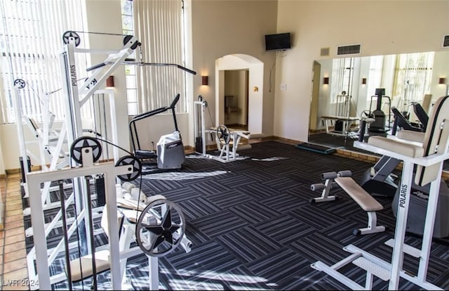 exercise room with a high ceiling