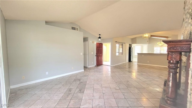 unfurnished living room with light tile patterned flooring and lofted ceiling