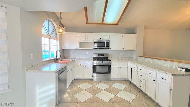 kitchen with kitchen peninsula, stainless steel appliances, sink, white cabinets, and hanging light fixtures