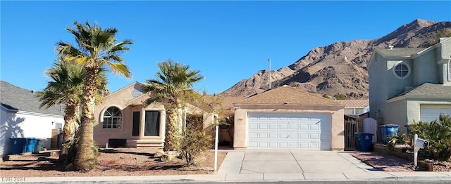 view of front facade featuring a mountain view and a garage