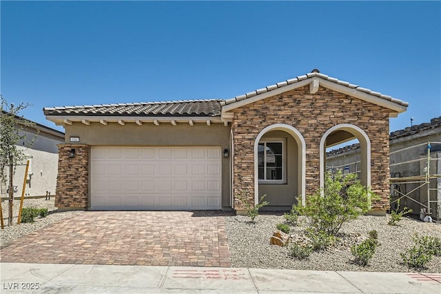 104 Barkset Way, Henderson, NV 89011 - view of front of home with stone siding, a tile roof, decorative driveway, an attached garage, and stucco siding