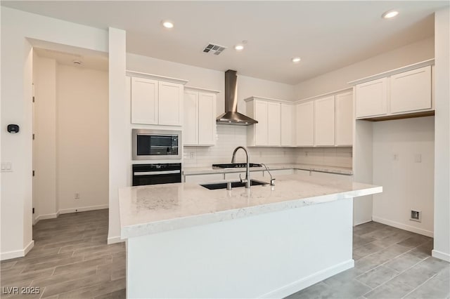 104 Barkset Way, Henderson, NV 89011 - kitchen featuring oven, wall chimney range hood, built in microwave, tasteful backsplash, and recessed lighting