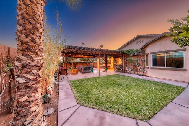 yard at dusk featuring outdoor lounge area, a pergola, and a patio