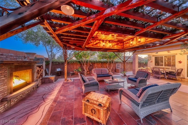 patio terrace at dusk featuring an outdoor living space with a fireplace