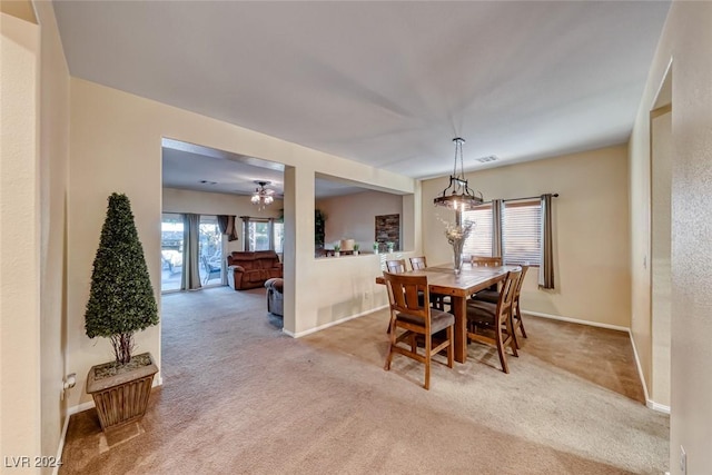 carpeted dining area featuring ceiling fan