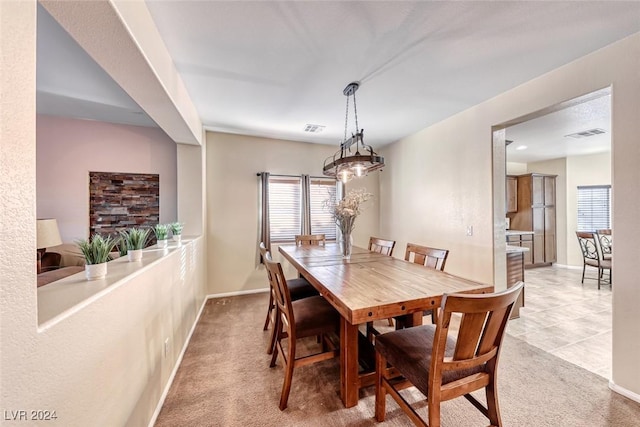 dining space featuring light colored carpet