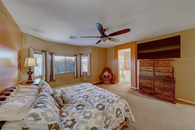 carpeted bedroom featuring ceiling fan and connected bathroom