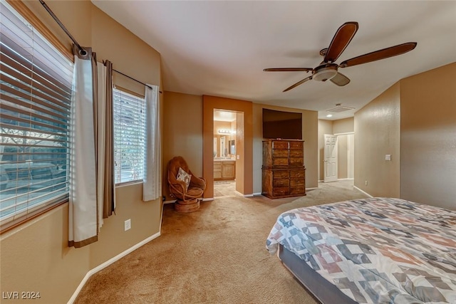 bedroom featuring connected bathroom, ceiling fan, and light colored carpet