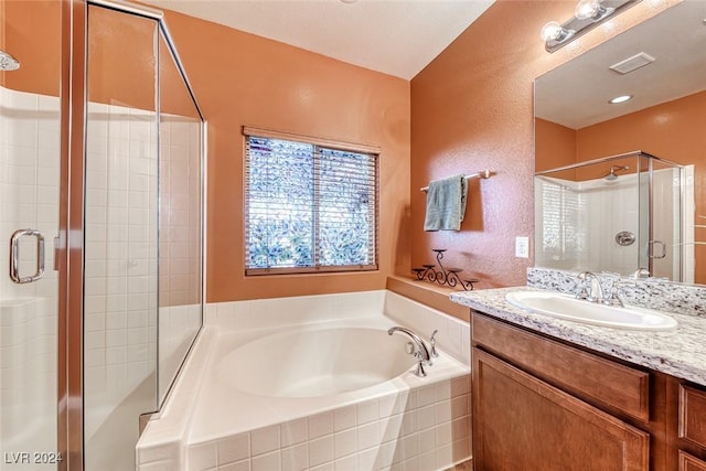 bathroom with plus walk in shower and vanity