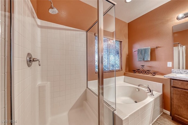 bathroom featuring vanity and shower with separate bathtub