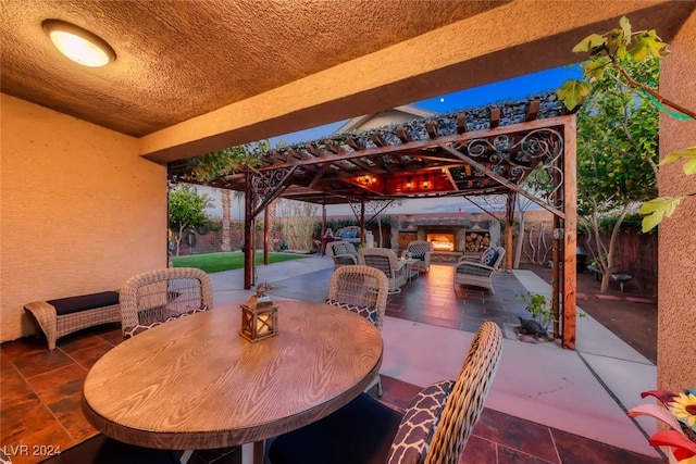 view of patio featuring an outdoor living space with a fireplace and a pergola