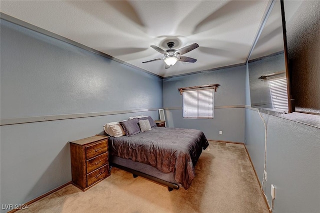 bedroom featuring ceiling fan and light carpet