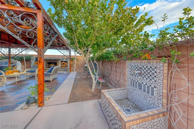 view of patio / terrace with an outdoor living space with a fireplace