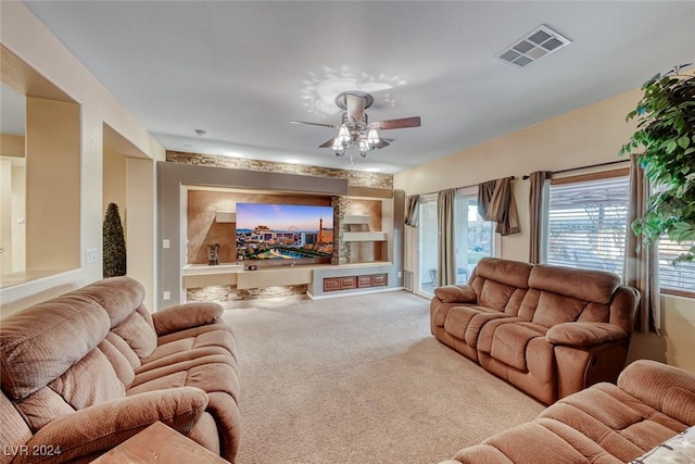 carpeted living room featuring ceiling fan