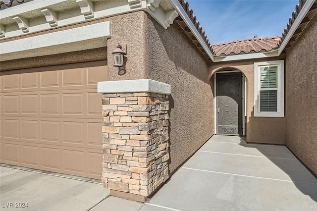 view of exterior entry featuring a garage