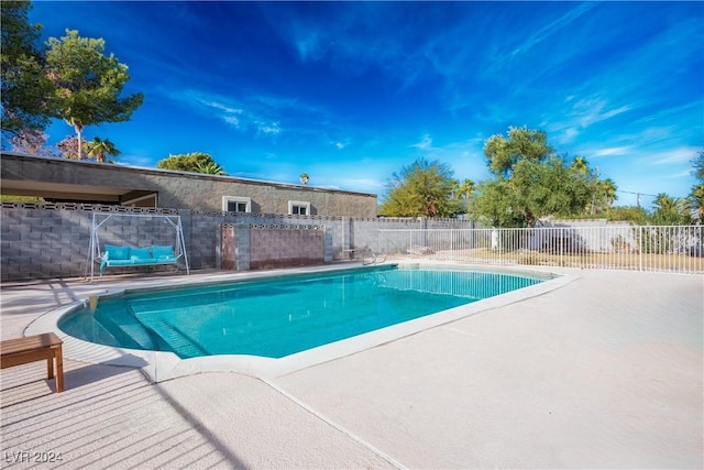 view of swimming pool featuring a patio area