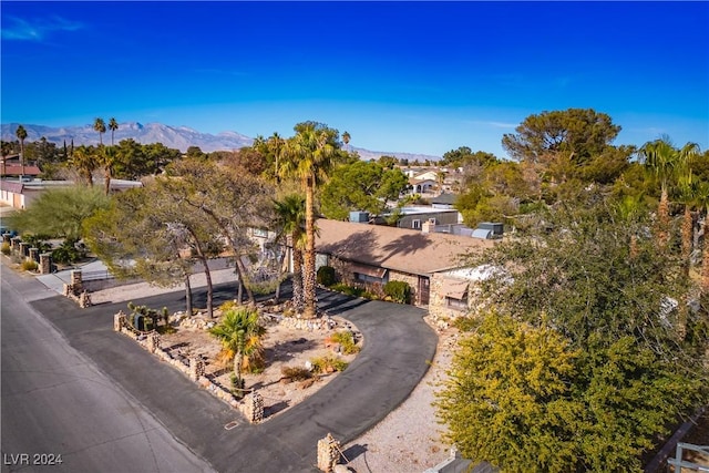 birds eye view of property with a mountain view