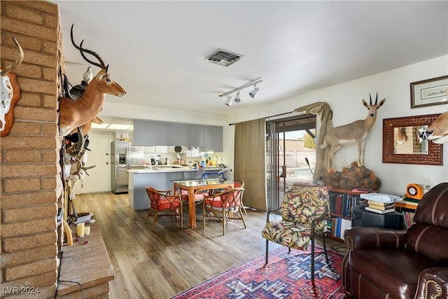 living room with hardwood / wood-style flooring and rail lighting