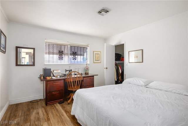 bedroom with light hardwood / wood-style flooring and ornamental molding