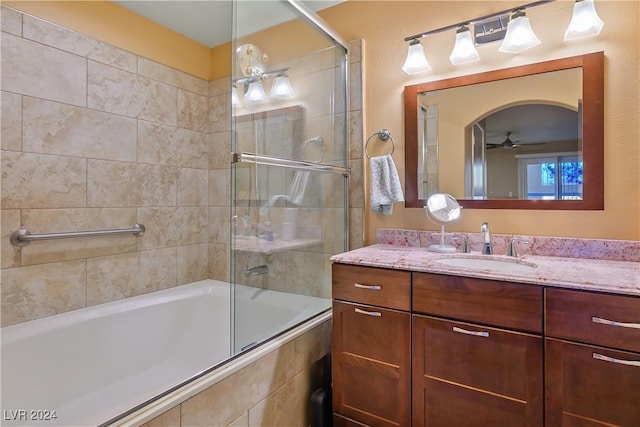 bathroom featuring vanity, shower / bath combination with glass door, and ceiling fan