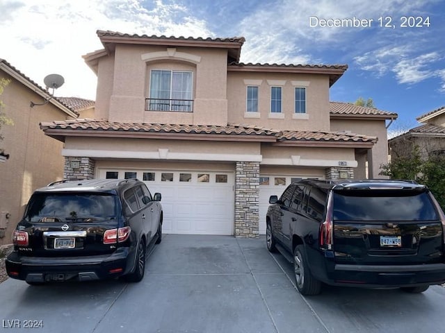 mediterranean / spanish home with a garage