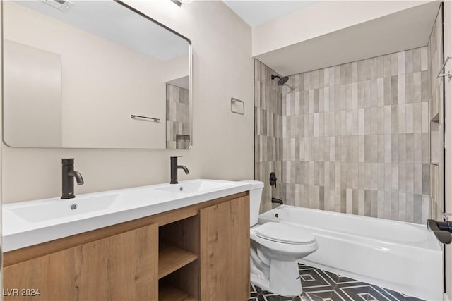 full bathroom featuring vanity, tiled shower / bath combo, and toilet