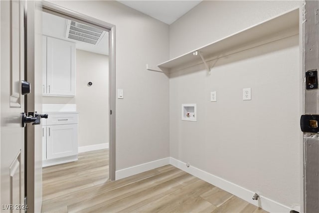 washroom with hookup for a gas dryer, washer hookup, and light wood-type flooring