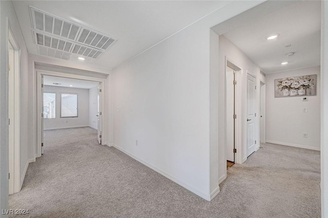 corridor with light colored carpet