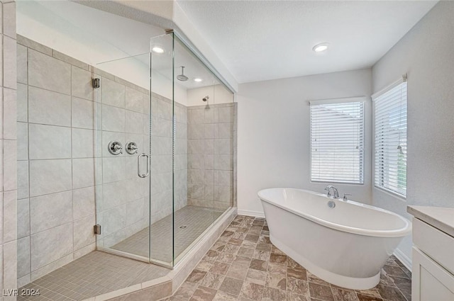 bathroom with plus walk in shower and vanity