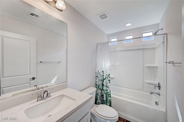 full bathroom with shower / bath combo with shower curtain, vanity, and toilet