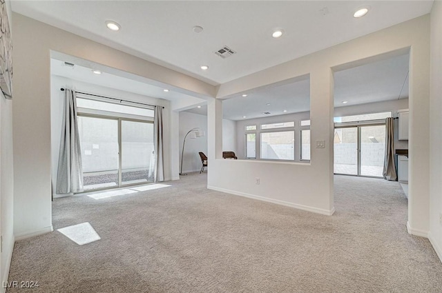 unfurnished room featuring light colored carpet