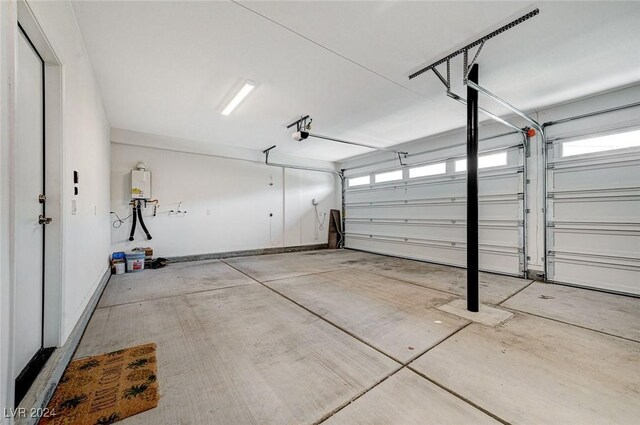 garage featuring a garage door opener and water heater