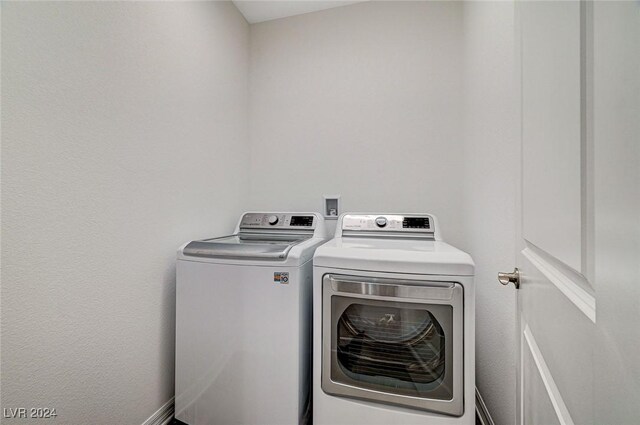 clothes washing area featuring washing machine and dryer